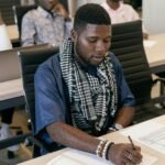 Young adults engaged in study session in a modern education setting.
