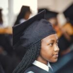 Portrait of a young graduate in cap and gown during a ceremony in Nairobi, Kenya.